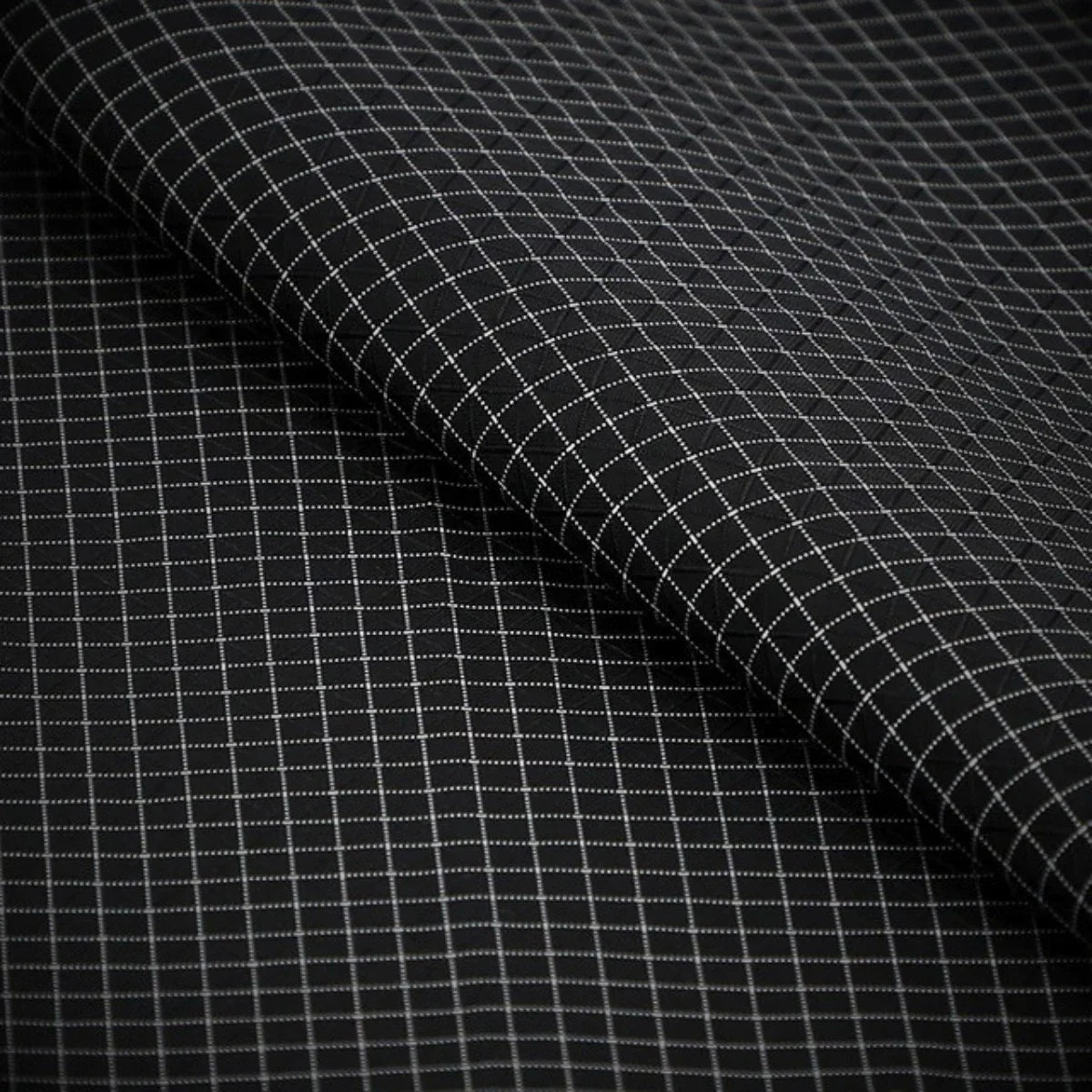 Dyneema ripstop lining macro showing the reinforcing grid, laser-cut interior material used in COLDFIRE wallets