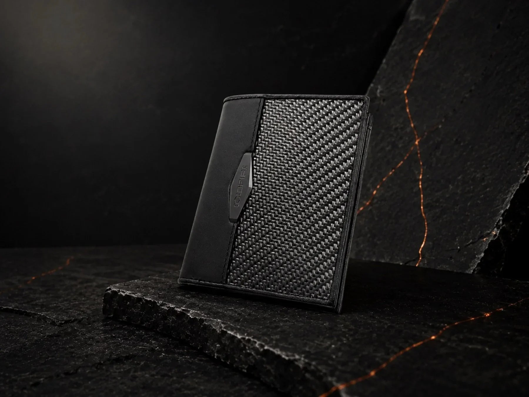 Best slim wallets for men 2026: COLDFIRE carbon fiber wallet on dark stone